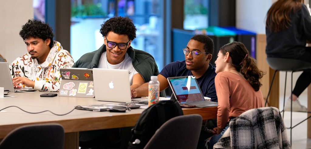 Students talk at a table