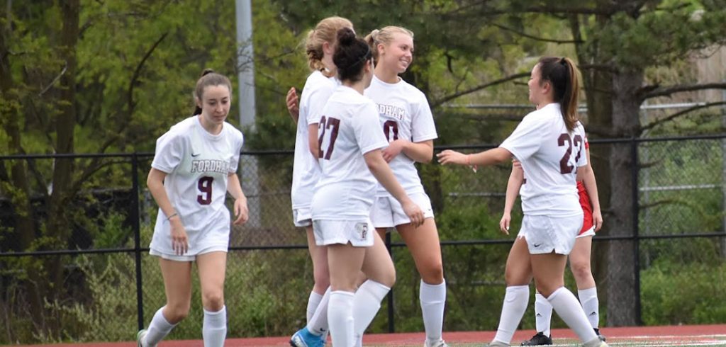 Teammates on the Women's Club Soccer team gather to celebrate a goal