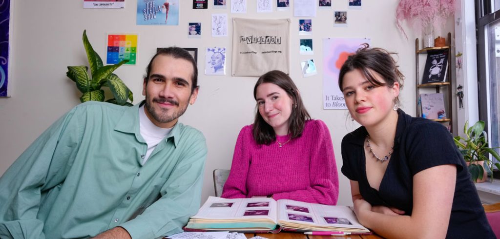 Three people smile for a photo