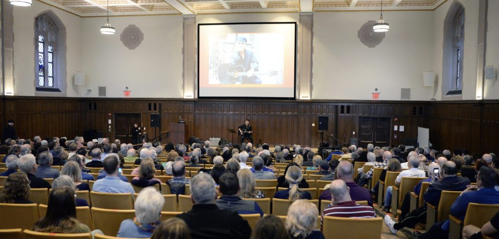 Dion performs for a large crowd of students, faculty, staff, and many guests from the nearby Belmont section of the Bronx.