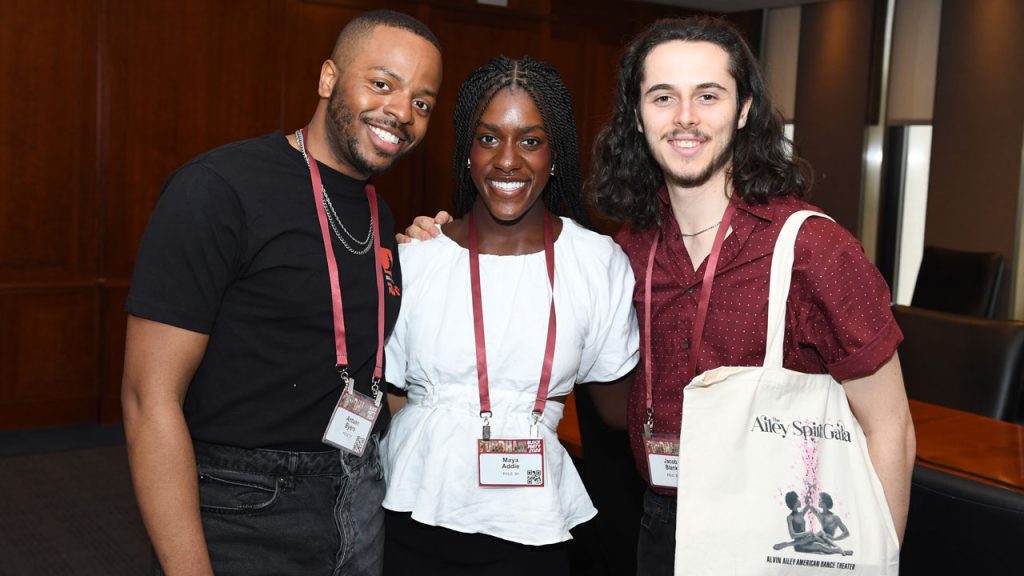 Three people pose for a photo