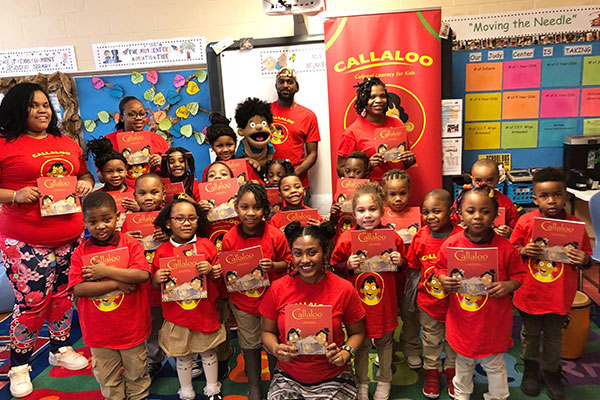 Marjuan Canady posing with a group of children for a Callaloo book event.