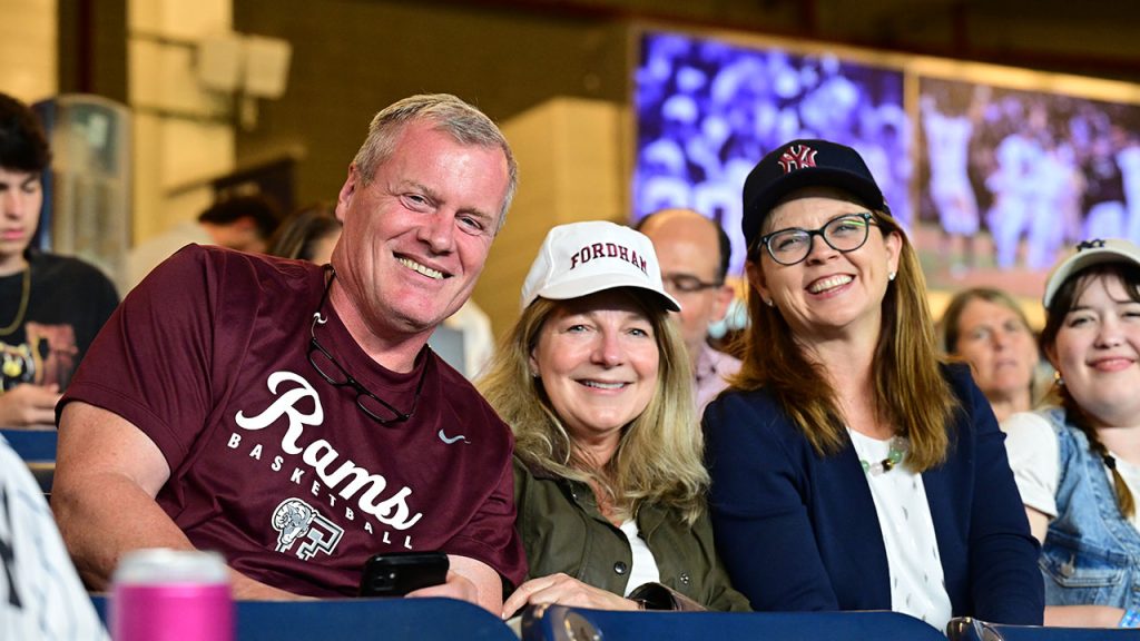 Three Yankee fans watch the game