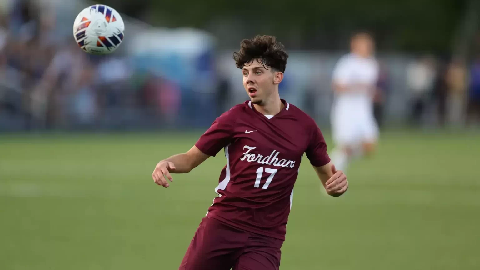 Daniel Lang playing soccer in maroon uniform