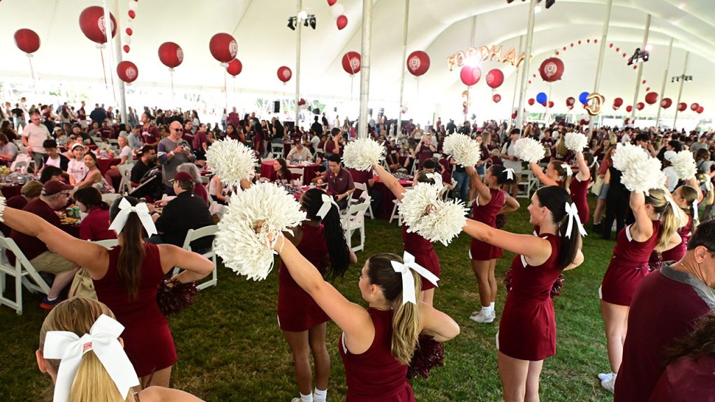 The Fordham cheerleading team performs pre-game on Edward's Parade.