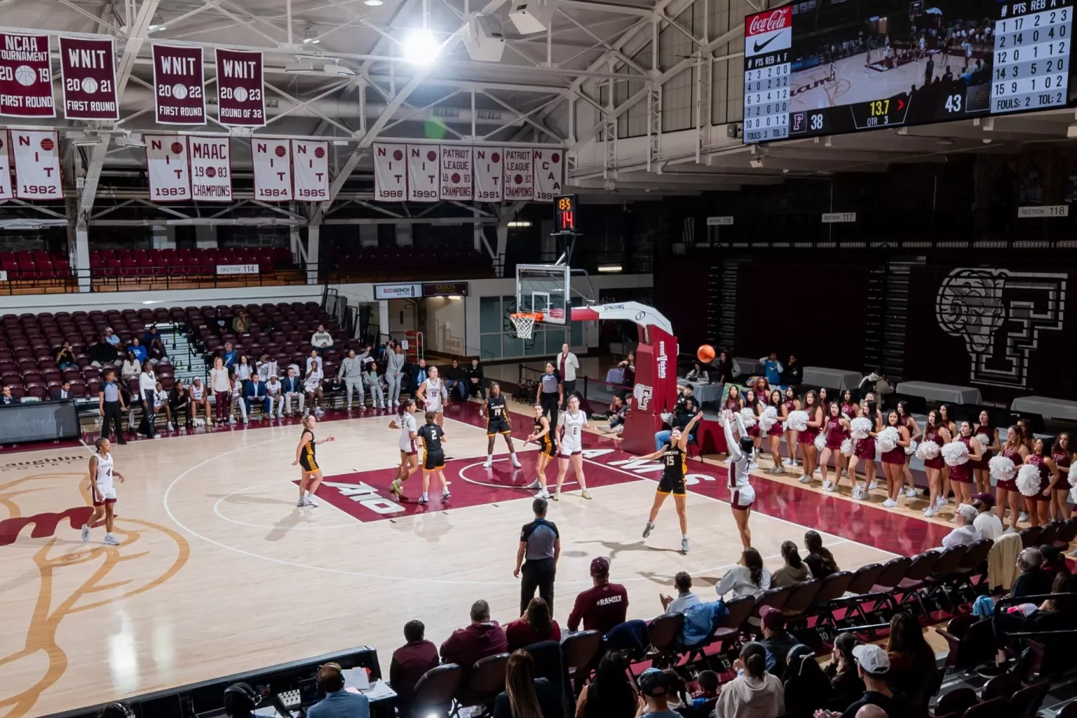 Women's basketball playing another team on court