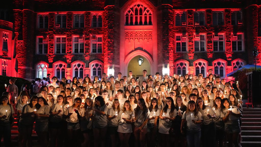 Group of students on Keating steps, during the candle lighting ceremony. All holding candles.