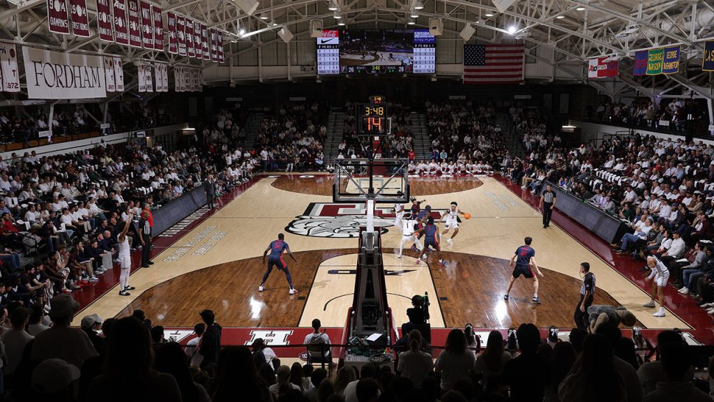 A view from the top of the bleachers behind one basket of a sellout crowd in Fordham's Rose Hill Gym during a men's basketball game