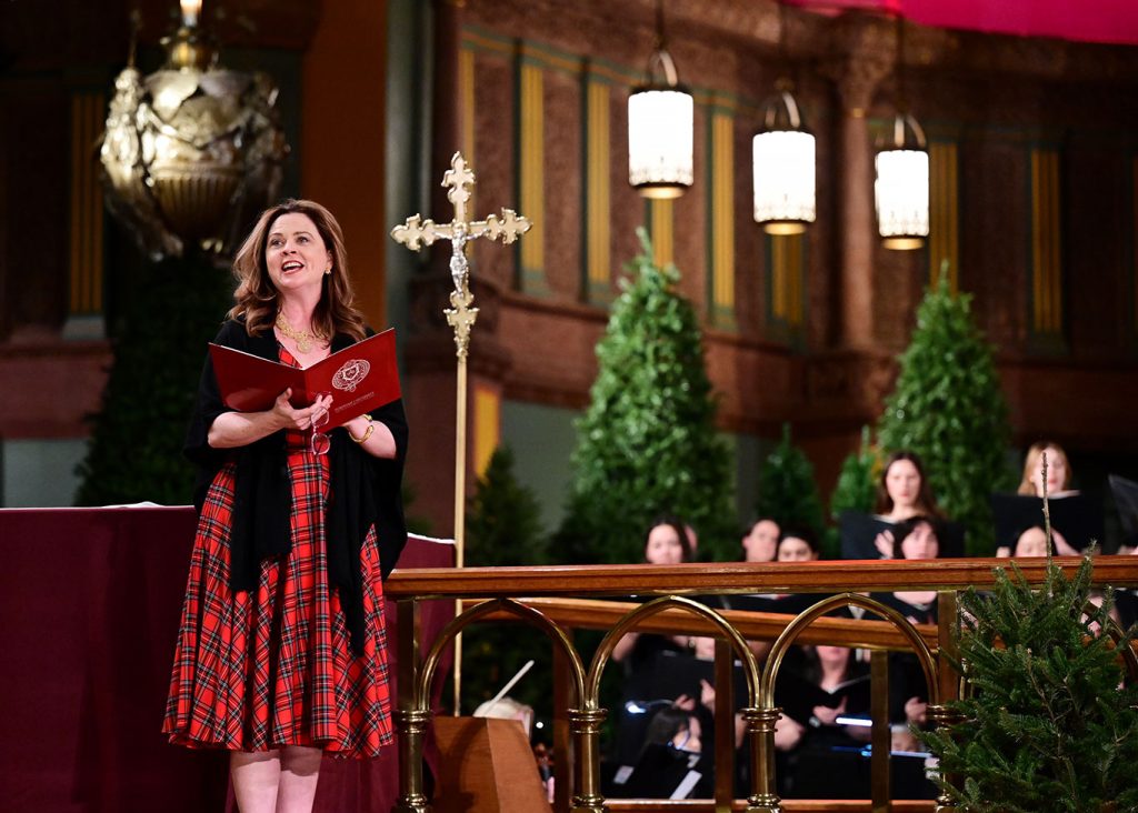 President Tetlow stands on the altar singing.