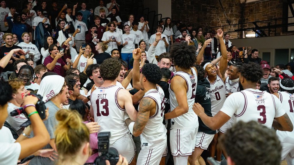 Basketball team celebrates with fans