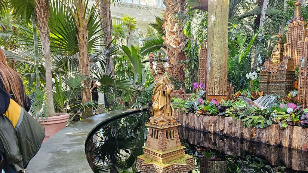 Statue of Liberty display at the Holiday Train Show. Empire State Building and other buildings to the back right. 